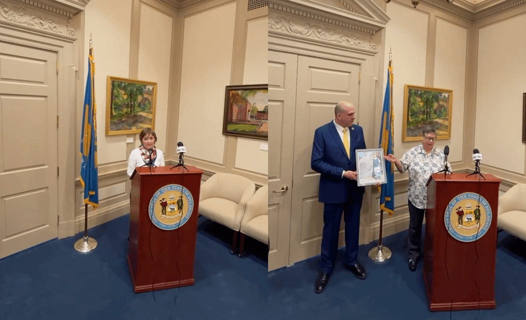 Judy Govatos (left) and Susan Lahaie and Kevin Díaz, President/CEO for Compassion & Choices/Compassion & Choices Action Network, holding a framed photo of her husband Ron Silverio (right) during Governor Meyer’s public signing ceremony on May 20.