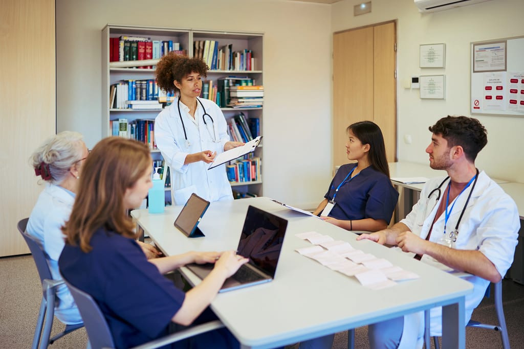 medical team meeting discussing patient cases in h 2026 01 09 10 31 07 utc