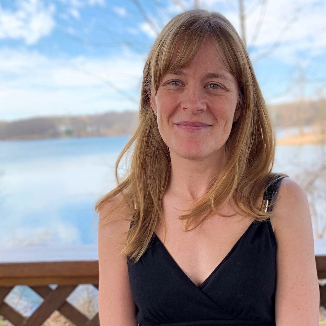 Angie Sovak Seated overlooking a body of water