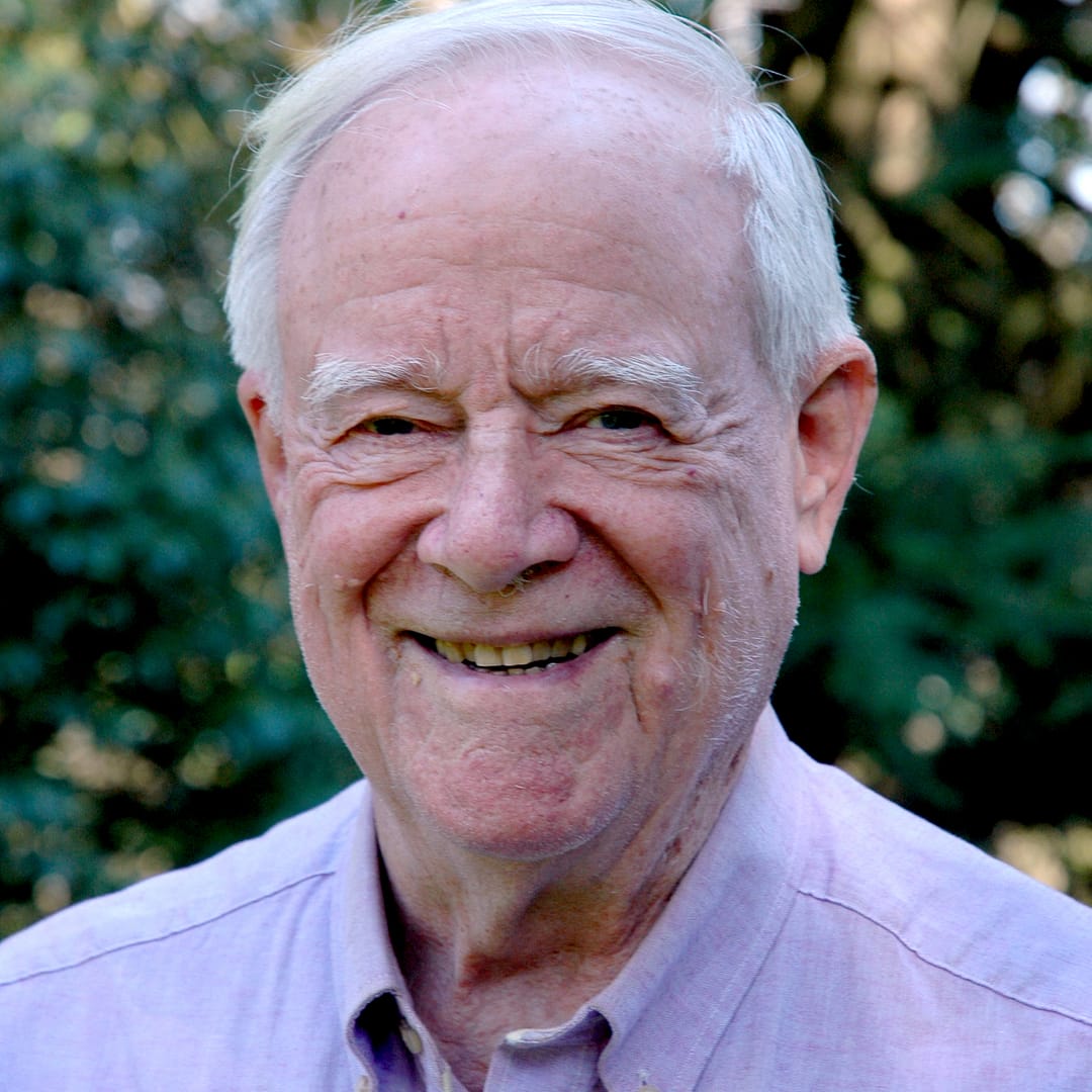 Grant Grissom Smiling wearing a purple shirt in front of greenery