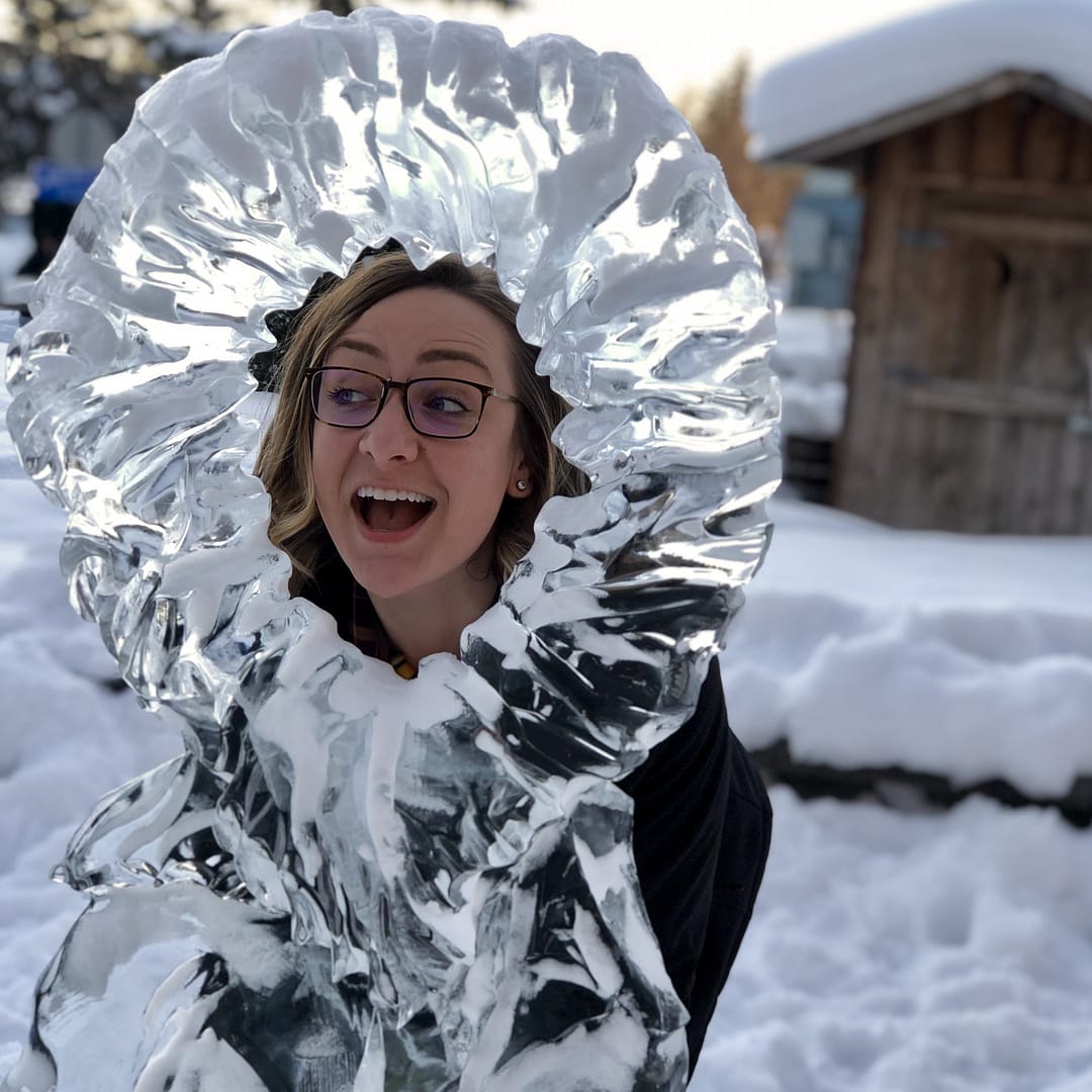 Rachel Bernhardt posing behind an ice sculpture
