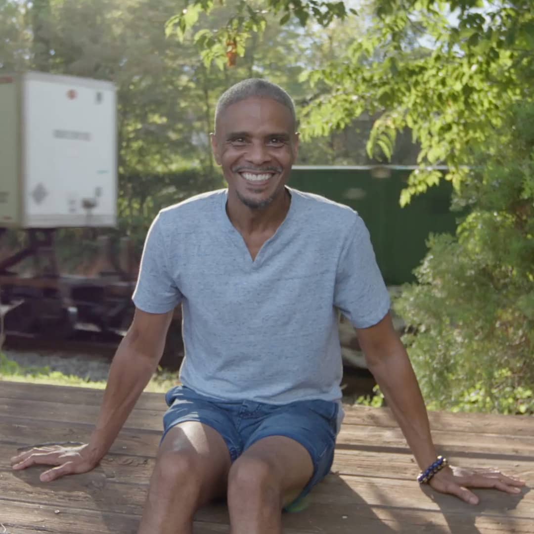 Thomas Reed Jackson seated in front of a parked train in the background.