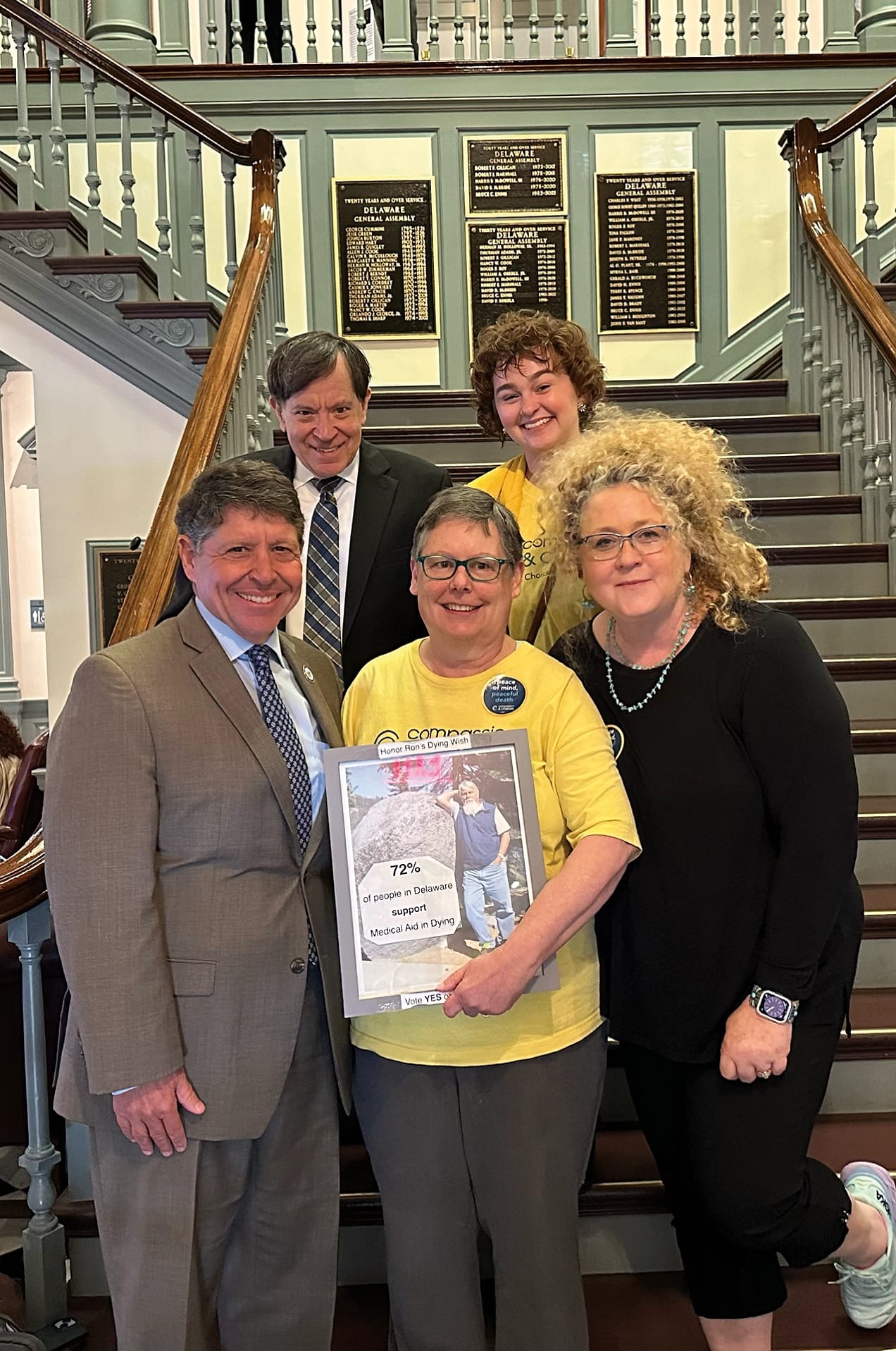 Rep Baumbach, advocates and Compassion & Choices staff celebrate the passage of HB140 from the Delaware legislature. Susan Lahaie (middle) holds a photo of her late husband, Ron Silverio, for whom the bill is named.