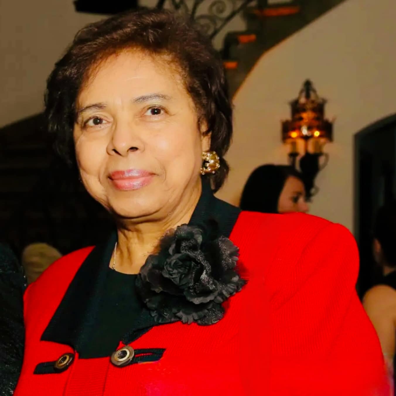 Dr. E. Faye Williams smiling wearing a red blazer.