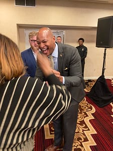 Gov.-elect Wes Moore greets Compassion & Choices Action Network Maryland Campaign Director Donna Smith