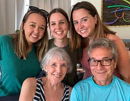 a family of five poses together