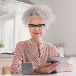 Woman smiling holding an ipad
