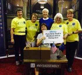 New York Supports holding a sign.