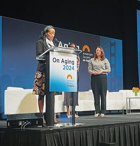 Brandi Alexander speaking at a podium