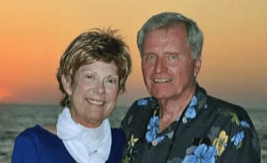 Judge Elizabeth Whitefield, for which the bill was named, and her husband stand at a beach with the sunset behind them