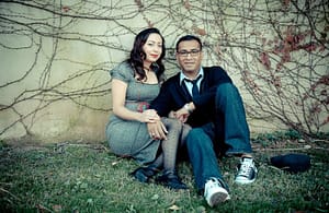 Ana and Juan Fernando Romero seated in front of a wall covered in vines