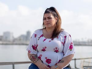 Hanna Olivasy seated in front of a skyline