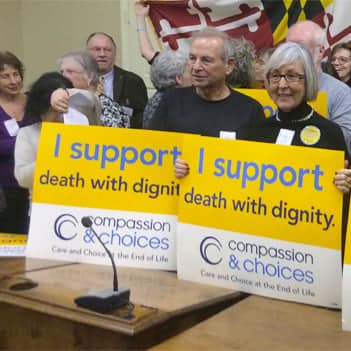 Compassion & Choices Supporters holding signs.