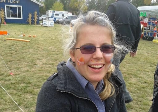 Ana Nelson pictured at a festival smiling with face paint