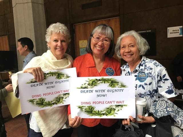 Women holding Death with Dignity Signs