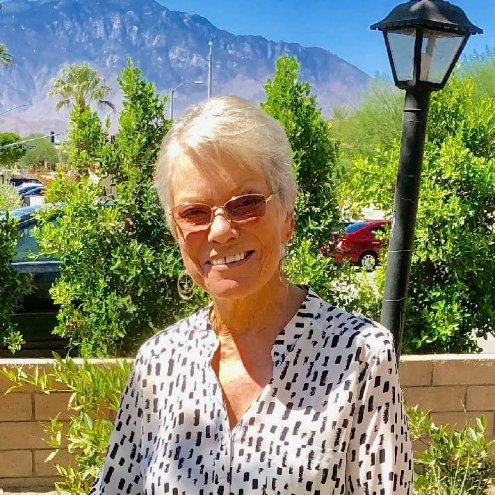Anita Rufus standing in front of a scenic mountain view