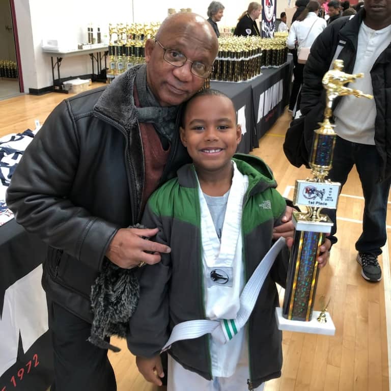 Oliver Ruff with a young boy holding a karate trophy