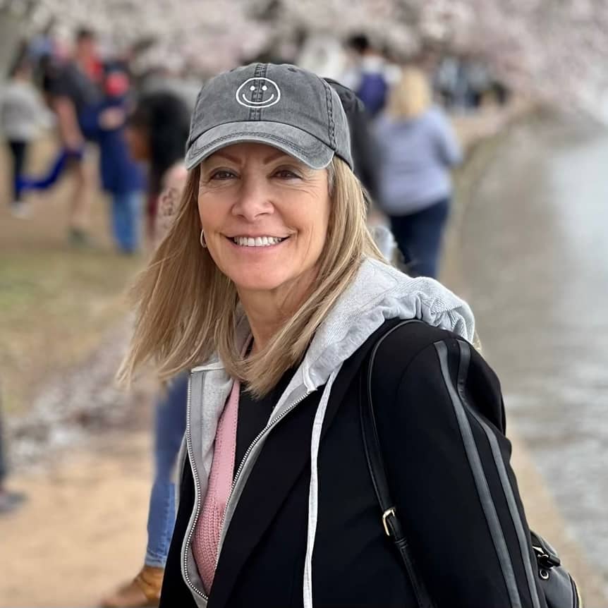 Lynda Brooks Bracey smiling outdoors next to a river