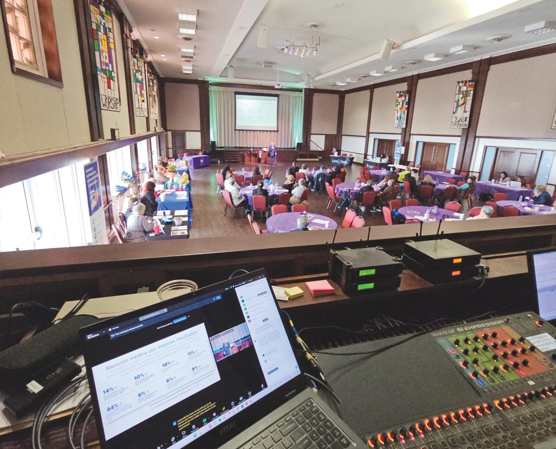 Compassion & Choices, Latinx Task Force and Face to Face collaborating while seated at round tables in an event hall in in Corpus Christi, Texas.