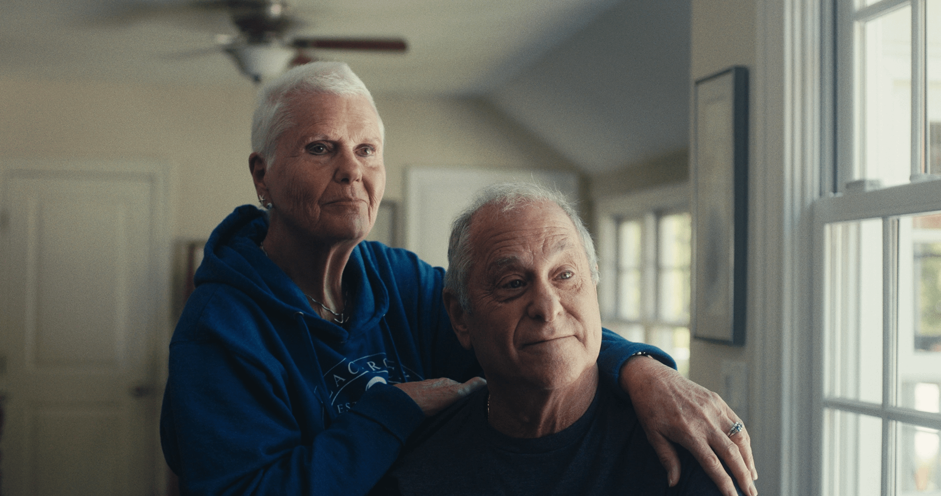 Lynda & Paul Bluestein posing a still from Other Side Film